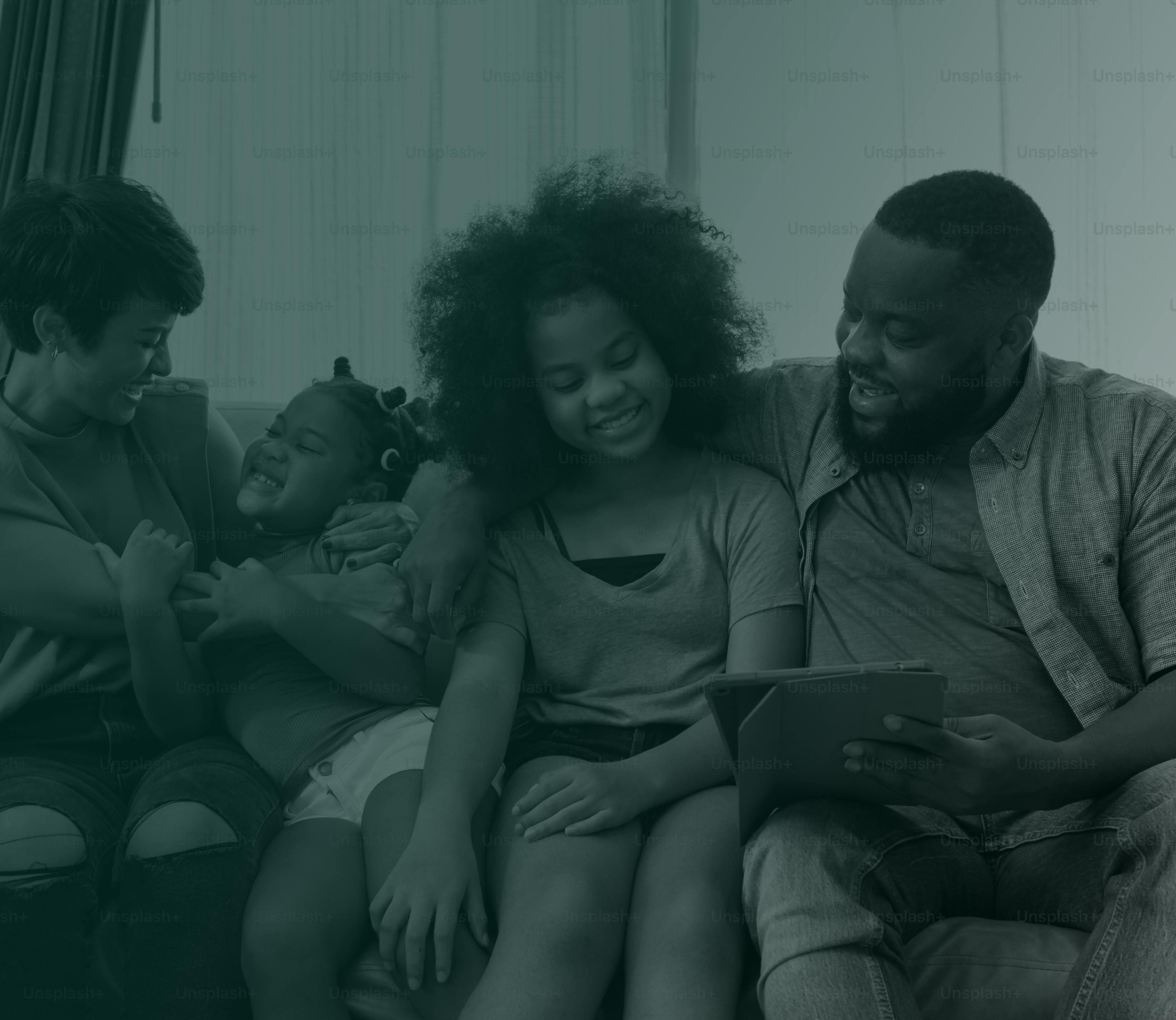 Family smiling looking at tablet.